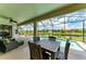 Screened-in pool and lanai featuring outdoor seating and dining furniture, and a view of the canal at 518 Chantilly Trl, Bradenton, FL 34212