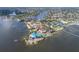 Aerial view of waterfront homes, showcasing the surrounding neighborhood and access to the ocean at 5912 Riverview Ln, Bradenton, FL 34209