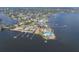 Stunning aerial view of waterfront home with private docks, lush landscaping, and serene water views at 5912 Riverview Ln, Bradenton, FL 34209