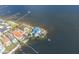 Magnificent aerial view of waterfront home with docks, lush greenery, and expansive bay scenery at 5912 Riverview Ln, Bradenton, FL 34209