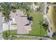 Aerial view of home with lush green lawn, mature trees and driveway at 5912 Riverview Ln, Bradenton, FL 34209