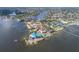 Aerial view of waterfront homes, showcasing the surrounding neighborhood and access to the ocean at 5912 Riverview Ln, Bradenton, FL 34209