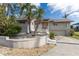 Lovely home showcasing mature palm trees, lush greenery, and an inviting front porch at 5912 Riverview Ln, Bradenton, FL 34209