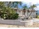 Charming home featuring lush tropical landscaping, palm trees and a welcoming front entrance at 5912 Riverview Ln, Bradenton, FL 34209