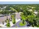 A bird's eye view showcasing lush landscaping with mature trees, and surrounding properties at 6222 Country Club Way, Sarasota, FL 34243