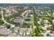 Wide aerial perspective showcasing neighborhood, community pool, and nearby water features at 6222 Country Club Way, Sarasota, FL 34243