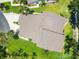 Aerial view of the home showcasing the roof, driveway, landscaping, and surrounding neighborhood at 6222 Country Club Way, Sarasota, FL 34243