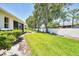 Expansive backyard featuring mature trees, privacy fence, and lush grass at 6222 Country Club Way, Sarasota, FL 34243