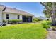 Expansive backyard featuring well-maintained lawn, mature trees, and a glimpse of neighboring homes at 6222 Country Club Way, Sarasota, FL 34243