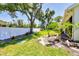 Landscaped backyard featuring mature trees, privacy fence, and lush grass at 6222 Country Club Way, Sarasota, FL 34243