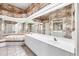 Bathroom featuring double sinks, vanity, shower and a large soaking tub at 6222 Country Club Way, Sarasota, FL 34243