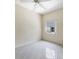 Bedroom features tile flooring, a ceiling fan, and large window for natural light at 6222 Country Club Way, Sarasota, FL 34243