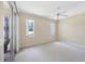 Bedroom featuring neutral carpet, natural light, and outdoor access at 6222 Country Club Way, Sarasota, FL 34243