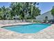 Community pool featuring lounge chairs and pristine landscaping for a relaxing atmosphere at 6222 Country Club Way, Sarasota, FL 34243