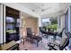 Screened lanai with ceiling fan and outdoor seating, open to interior room at 6222 Country Club Way, Sarasota, FL 34243