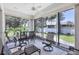 Screened lanai with ceiling fan and outdoor seating at 6222 Country Club Way, Sarasota, FL 34243