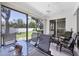 Screened lanai with ceiling fan and outdoor seating at 6222 Country Club Way, Sarasota, FL 34243