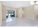 Spacious living room with tile floors and sliding glass doors leading to the outdoor patio at 6222 Country Club Way, Sarasota, FL 34243