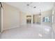 Spacious living room with tile floors, modern ceiling fan, and open bar area at 6222 Country Club Way, Sarasota, FL 34243