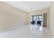 Spacious living room with tile floors and sliding glass doors leading to the outdoor patio at 6222 Country Club Way, Sarasota, FL 34243