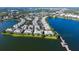 Panoramic aerial view of lakeside homes, pier, and lush green landscape at 6552 Moorings Point Cir # 201, Lakewood Ranch, FL 34202