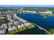 Aerial view of lakeside condos featuring an extended pier and beautiful blue lake at 6552 Moorings Point Cir # 201, Lakewood Ranch, FL 34202
