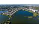 Aerial view showcasing the community's condos, lake, and lush green landscaping at 6552 Moorings Point Cir # 201, Lakewood Ranch, FL 34202