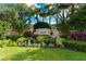 The Moorings at Edgewater entrance sign surrounded by well manicured landscaping and palm trees at 6552 Moorings Point Cir # 201, Lakewood Ranch, FL 34202
