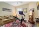Cozy workout room features stationary bike, weight bench, full-length mirror, and comfortable couch at 6552 Moorings Point Cir # 201, Lakewood Ranch, FL 34202