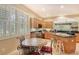 Open kitchen with custom cabinets, granite countertops, and an adjacent breakfast nook at 6552 Moorings Point Cir # 201, Lakewood Ranch, FL 34202