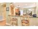 Kitchen bar with wood stools and granite countertop at 6552 Moorings Point Cir # 201, Lakewood Ranch, FL 34202