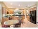 Open kitchen showcasing custom cabinets, granite countertops, a breakfast nook, and modern appliances at 6552 Moorings Point Cir # 201, Lakewood Ranch, FL 34202