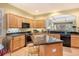 Open kitchen featuring custom cabinets, granite countertops, modern appliances, and bar stool seating at 6552 Moorings Point Cir # 201, Lakewood Ranch, FL 34202
