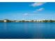 Beautiful lake view with the community in the background under a clear blue sky at 6552 Moorings Point Cir # 201, Lakewood Ranch, FL 34202