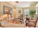 Bright living room showcasing stylish furniture, an artistic area rug, and plantation shutters at 6552 Moorings Point Cir # 201, Lakewood Ranch, FL 34202