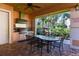 Outdoor kitchen with table, chairs, and grill at 6552 Moorings Point Cir # 201, Lakewood Ranch, FL 34202