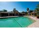 Spacious community pool with lounge chairs, umbrellas, and an outdoor structure at 6552 Moorings Point Cir # 201, Lakewood Ranch, FL 34202