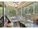 Inviting screened porch features two lounge chairs and a cafe table, perfect for relaxation at 6552 Moorings Point Cir # 201, Lakewood Ranch, FL 34202