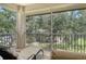 Relaxing screened porch with comfortable lounge chairs and views of the lush greenery at 6552 Moorings Point Cir # 201, Lakewood Ranch, FL 34202
