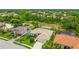 Lovely aerial view of a single-story home with a three-car garage, lush lawn and mature trees at 7126 Southgate Ct, Sarasota, FL 34243