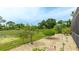 Landscaped backyard featuring a rock path, pond view, and lush green scenery that provides a serene environment at 7126 Southgate Ct, Sarasota, FL 34243