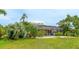 Backyard showcasing lush landscaping, a screened pool area, and mature trees, creating a private retreat at 7126 Southgate Ct, Sarasota, FL 34243