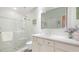 Bright bathroom featuring a glass enclosed shower and white vanity with a marble countertop at 7126 Southgate Ct, Sarasota, FL 34243