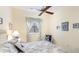 Comfortable bedroom featuring a decorative ceiling fan and a large window with curtains at 7126 Southgate Ct, Sarasota, FL 34243