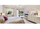 Bright bedroom featuring a king bed, access to the pool area, and natural light through the windows at 7126 Southgate Ct, Sarasota, FL 34243