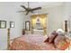 Bedroom featuring a bed, side table, ceiling fan, carpet, and curtains at 7126 Southgate Ct, Sarasota, FL 34243