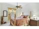 Bedroom featuring a bed, side table, ceiling fan, carpet, and curtains at 7126 Southgate Ct, Sarasota, FL 34243