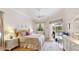 Bright bedroom featuring a king bed, access to the pool area, and natural light through the windows at 7126 Southgate Ct, Sarasota, FL 34243