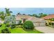 Charming single-story home with a well-manicured lawn and a three-car garage in a lush neighborhood at 7126 Southgate Ct, Sarasota, FL 34243