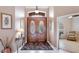 Elegant foyer with double wood doors, tile flooring, and decorative lighting at 7126 Southgate Ct, Sarasota, FL 34243